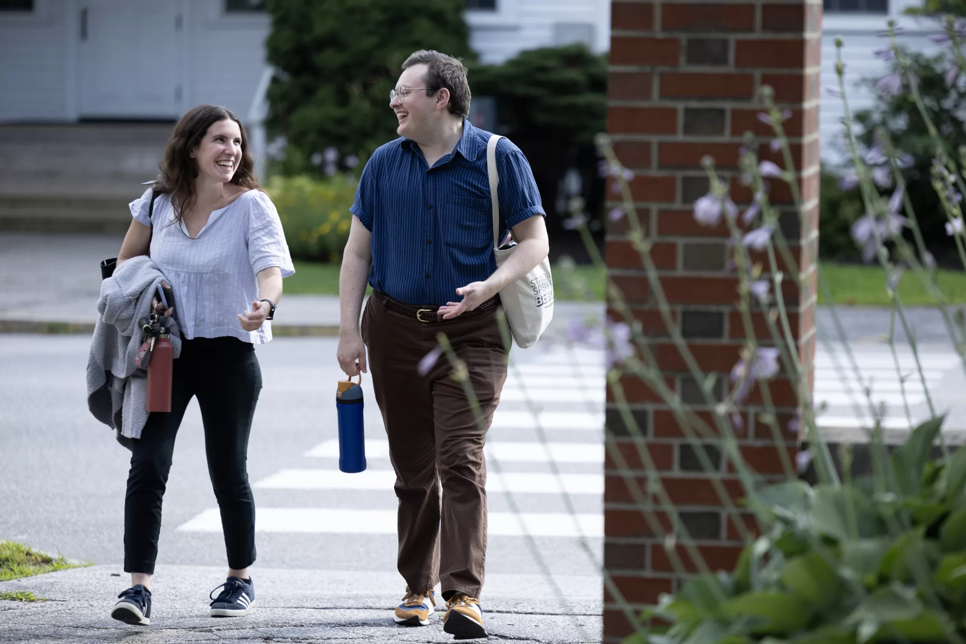Admission Counselors Erin Lachance and Jeremy McFarland end their day with a stroll through the Class of 1906 Gate, a Campus Avenue entry to the Historic Quad.