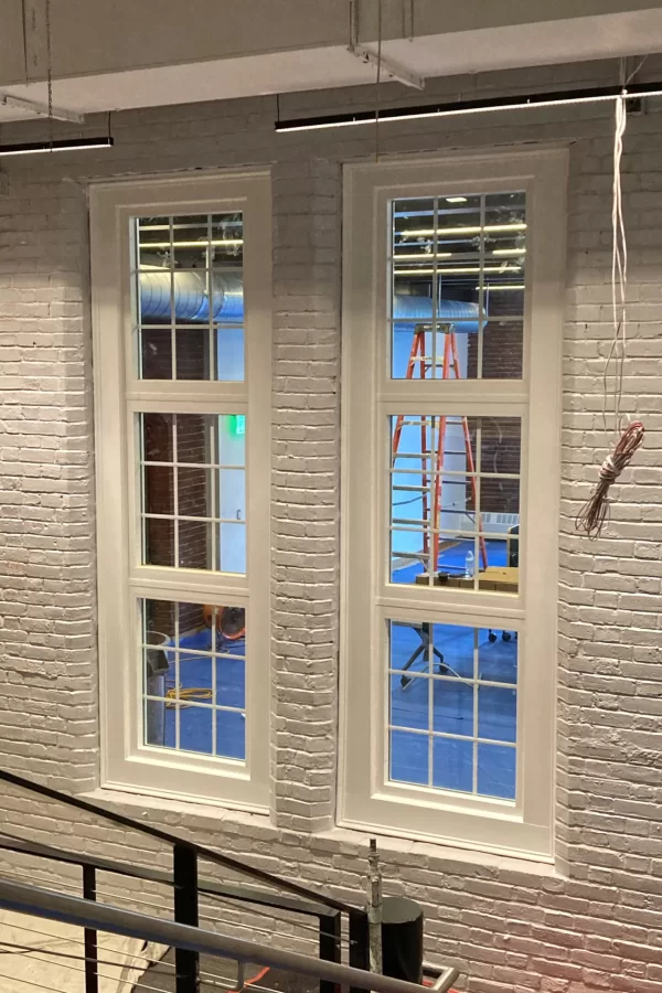 At one time this wall separating the Central Stair and Chase Hall Lounge was the rear outside wall of Chase Hall. During the recent renovation, the old window openings were restored and reglazed to add visual interest to the building’s interior. (Doug Hubley/Bates College)