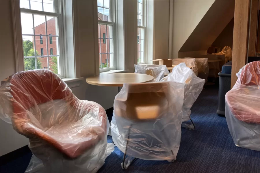 Plastic covers still protect much of the new furniture in a second-floor lounge in Chase Hall. (Doug Hubley/Bates College)