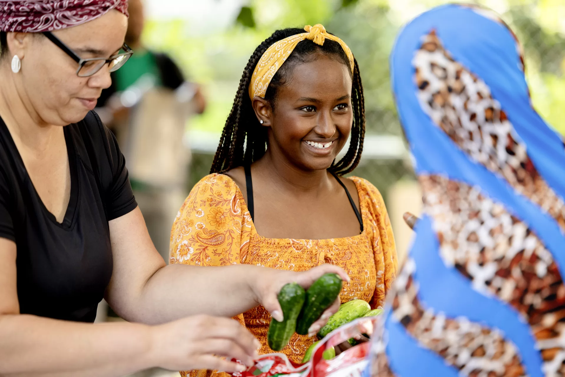 Student: Nimco Jama ’24 of Hargeisa, Somaliland, working at the food bank during her Purposeful Work internship on Aug. 3, 2023.

Place: Trinity Jubilee Center, Lewiston

Work: Helping Trinity Jubilee in its work to address unmet needs of under-served people in the area through collaboration with local, state, and federal organizations, as well as other agencies and churches.

Shown with Trinity Jubilee Center Executive Director Erin Reed ’04(in blue sweatshirt, Tonya Sands (black t-shirt), Trinity Jubilee’s Day Shelter Manager, and staff member in white t-shirt from the New Mainers Public Health Initiative.