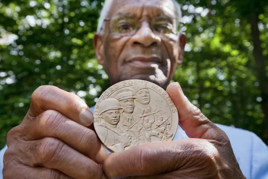 Nathaniel Boone '52 poses with his wife who now lives in Manchester Center, Vt., Harriet Howell Boone outside of their Manchester Center, Vt., home, after Boone received a Congressional Gold Medal for his service as one of about 400 surviving "Montford Point Marines," the first African Americans to serve in the U.S. Marine Corps. Given basic training in the 1940s at the racially segregated Montford Point facility at Camp Lejeune, N.C., more than 19,000 black Marines broke the Corps color barrier in a time and place where desegregation was anything but welcome.