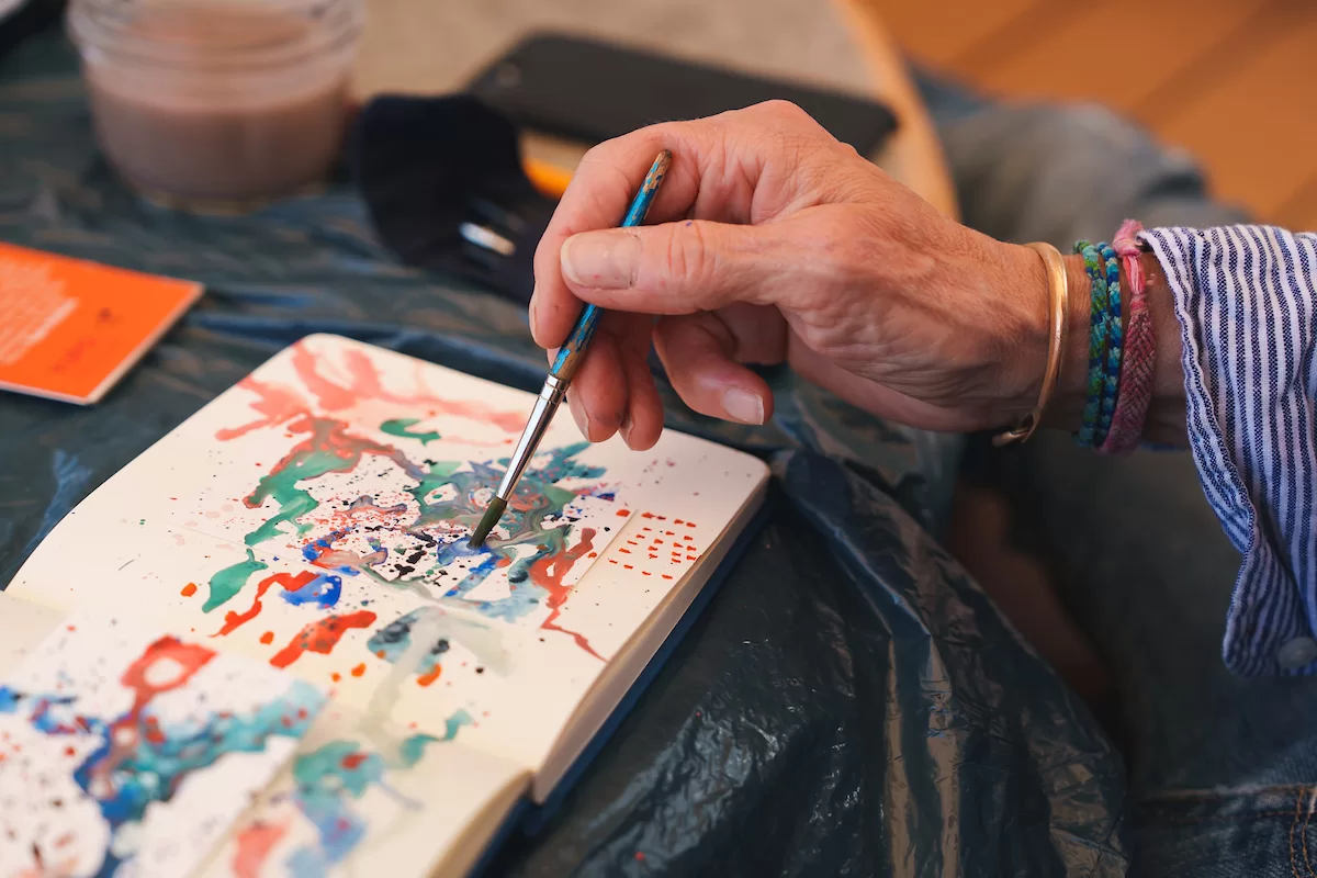 Michel Droge (Artist, Bates College) begins work in their small sketchbook. Each day they use this as visual diary of their experiences and thought process. (Photo courtesy of the Schmidt Ocean Institute)