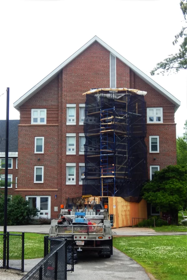Staging erected next to Hopkins House marks where new window units are being installled. It’s the second summer for such replacements at the Residential Village. (Doug Hubley/Bates College)