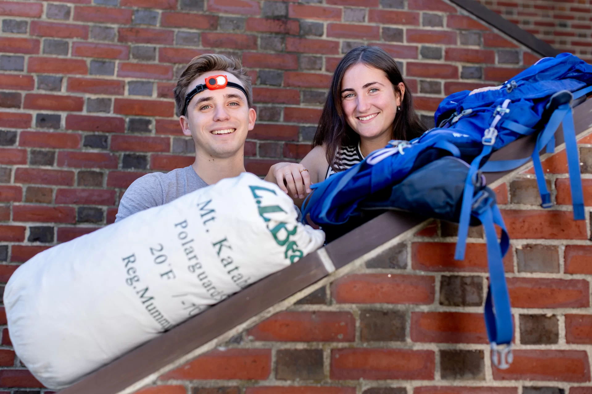 ASEOP coordinators Casey Shultis ’24 of Portland, Ore., and Maeve McSloy ’24 of Old Greenwich, Conn., pose for portraits outside and inside of  Chase Hall, where they are using Memorial Commons as a gathering center for equipment and food for upcoming AESOP trips for the incoming Class of 2027.