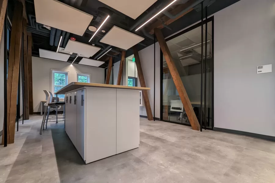 This “bar” in the Purposeful Work suite is equipped with lockers for staff and student workers to stow their stuff. The angled wooden beams are load-bearing trusses that are original to century-old Chase Hall and have been left exposed as a reminder of the building’s long history. (Kristi Mynhier/Bates College)