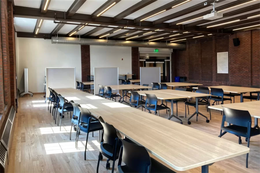 Chase Hall Lounge post-renovation. Note the new location of the entrance, and to the right of that, the three indented rectangles — exterior windows that were bricked in when the building was expanded in the late 1940s. (Doug Hubley/Bates College)