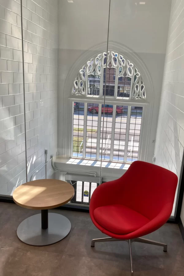 Both here in the Purposeful Work suite and one flight up in the second-story lobby, the floors were extended into the former Campus Avenue stairwell to help bring daylight more deeply into Chase Hall. (Doug Hubley/Bates College)