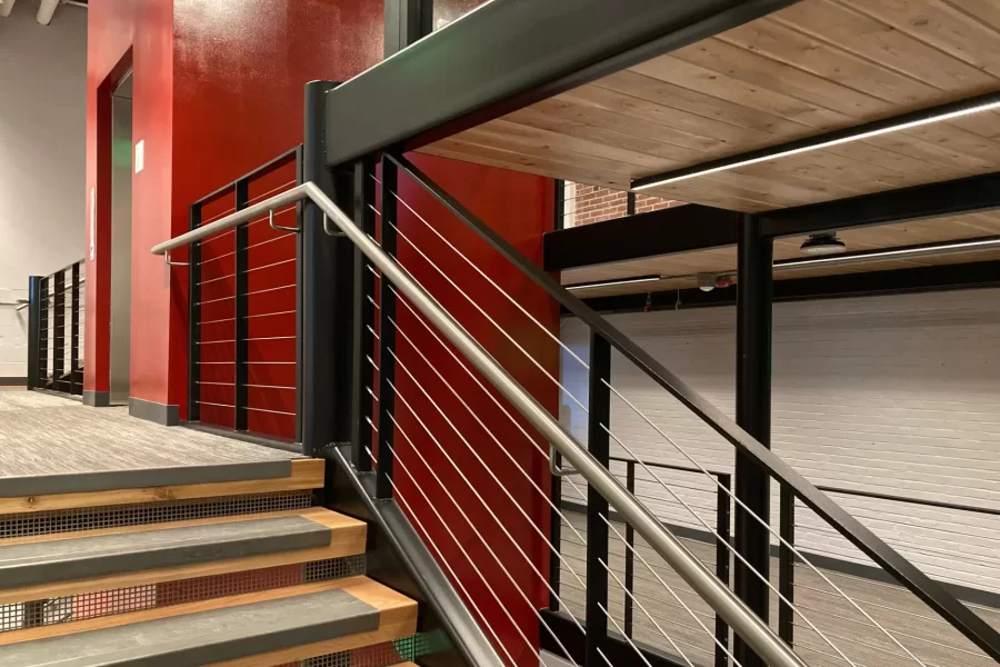 Oak stair treads, blond high-tech floor decking, LED accent lights, and metal handrails all add to the Central Stair’s stylish appeal. (Doug Hubley/Bates College)