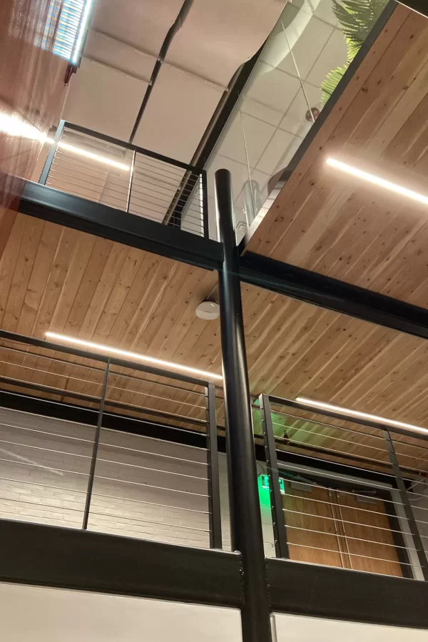 Looking up through the Central Stair. The blond wood is cross-laminated timber, a wood product that’s greener than a traditional concrete and steel structure and much faster to install. (Doug Hubley/Bates College)