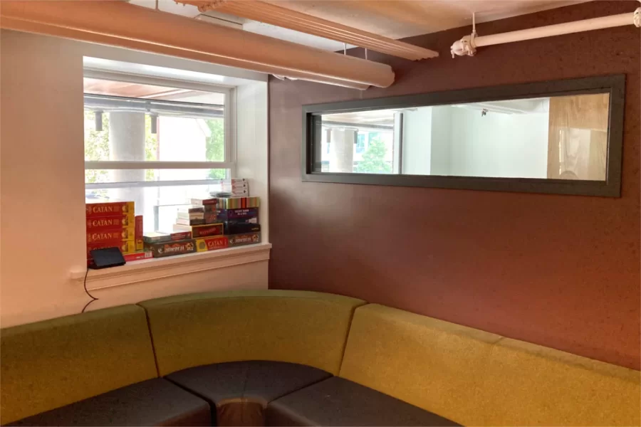 Comfy seating in the Residence Life offices. Stacked on the windowsill are board games that Res Life staff can borrow for student social events. (Doug Hubley/Bates College)