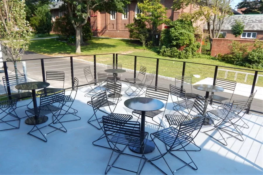 Cafe-style furniture lends an Old World ambience to this patio created from what was formerly the Dining Services loading dock. (Doug Hubley/Bates College)