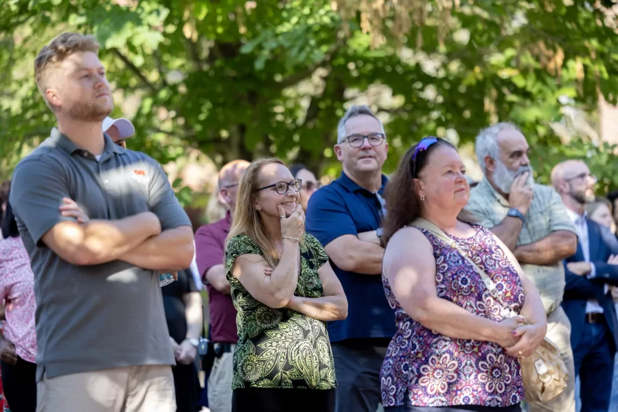 Bates staff look and listen on Sept. 7 as President Garry Jenkins offers remarks prior to the ribbon-cutting that reopened Chase Hall after a 14-month renovation. (Phyllis Graber Jensen/Bates College)