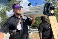 Cole De Magistris ’24, an economics and rhetoric, film, and screen studies double major from Emerson, N.J. He had a purposeful work internship during August 2023 with the Minnesota Vikings training facility in Eagan, Minn. He was photographed here on Aug. 21, 2023. Work: Supporting marketing, fan engagement, and guest services initiatives included with Fan Village, the Vikings’ fan experience program during training camp.