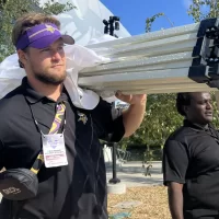 Cole De Magistris ’24, an economics and rhetoric, film, and screen studies double major from Emerson, N.J. He had a purposeful work internship during August 2023 with the Minnesota Vikings training facility in Eagan, Minn. He was photographed here on Aug. 21, 2023. Work: Supporting marketing, fan engagement, and guest services initiatives included with Fan Village, the Vikings’ fan experience program during training camp.