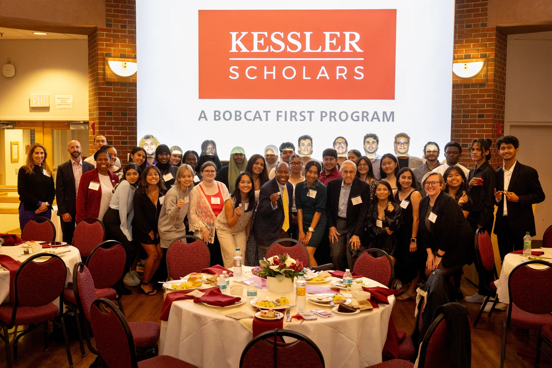 Introducing your 2023-24 Kessler Scholars!

President Garry W. Jenkins (@presgarryjenkins) poses with the college's first and already amazing cohort of Kessler Scholars during a Sept. 13 Kessler Scholars Coin Ceremony. The ceremony kicked off the scholars' bright journey at Bates and beyond and helped to welcome the scholars to the National Kessler Scholars Collaborative.

Kessler Scholars, a Bobcat First Program, provides holistic support, including mentoring, for a diverse community of high-achieving Bates students who are the first in their family to pursue a four-year college degree.

In the second photo, Azajul Islam Neloy ’27 of Dhaka, Bangladesh, proudly holds a commemorative coin, presented to each new Kessler Scholar in the Bates Class of 2027 during the ceremony and dinner. “The support I have received as a Kessler Scholar from Bates has exceeded all of my expectations,” Neloy said. “The personalized mentoring sessions for the Kessler Scholars have given this initiative a new dimension. As an international student, I am immensely proud and honored to represent my country, Bangladesh, in the Kessler Scholars community.”

(Phyllis Graber Jensen/Bates College)