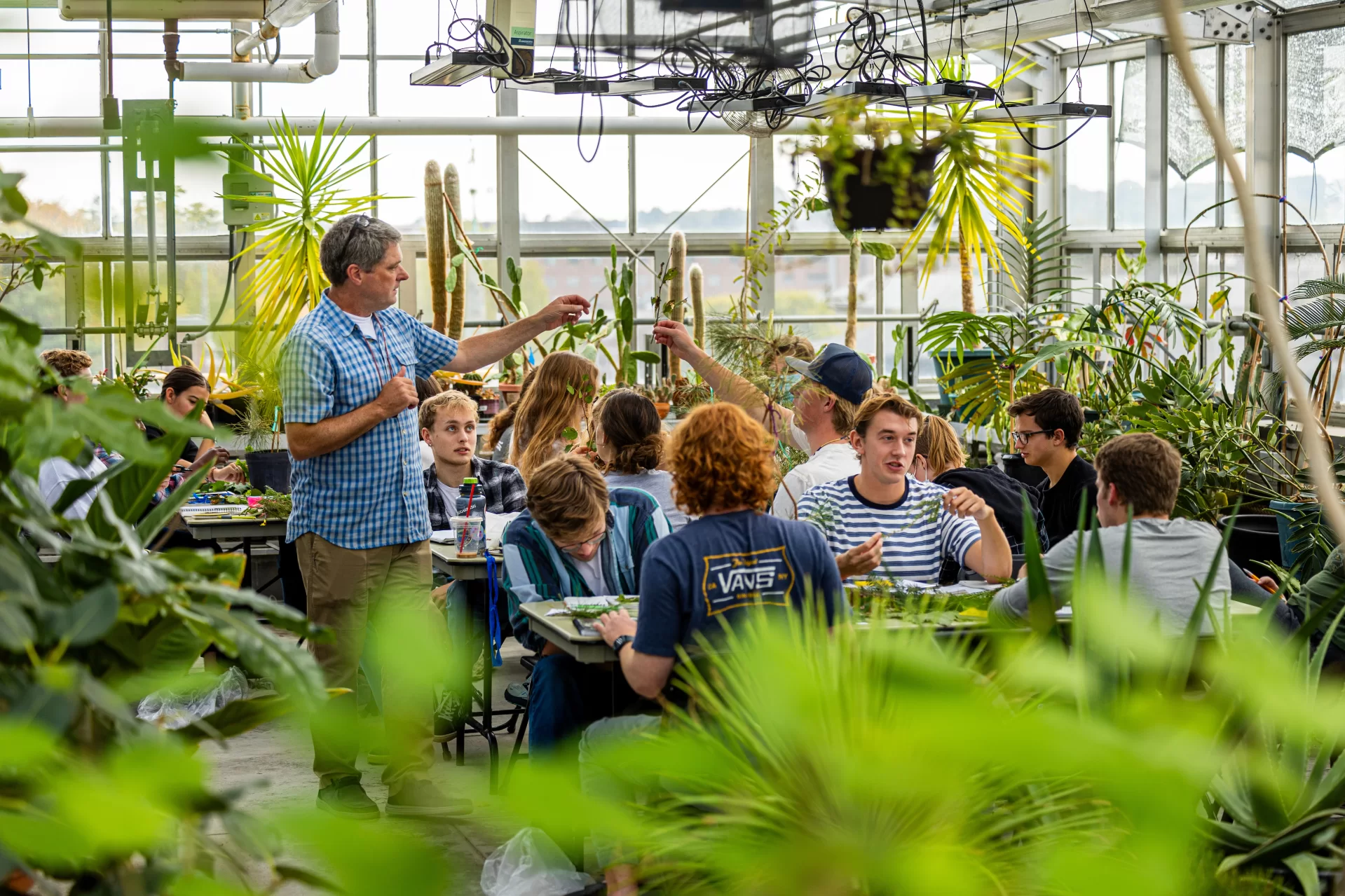 “Usually at this hour, we’d be down in the lecture hall.”
—Associate Professor of Biology Brett Huggett explaining why he took his dendrology students to the Carnegie Greenhouse rather than have them remain in the classroom to identify tree species.
Huggett teaches BIO 271/Dendrology and the Natural History of Tree, a field-based course in which students engage in the scientific study of the natural history and identification of trees and important shrubs native to New England, and some commonly planted non-native trees. Topics include the anatomy, function, taxonomy, biology, and uses of trees. Lecture topics support weekly outdoor laboratories, which may include trips to such field sites as the Saco Heath, Thorncrag Bird Sanctuary, and Wolfe's Neck State Park. Study of the woody flora of New England serves as a foundation for further work in biology, environmental studies, conservation, or related fields.
(Phyllis Graber Jensen/Bates College)
#batescollege #biology #stem #tress #dendrology #liberalarts #faculty #lab