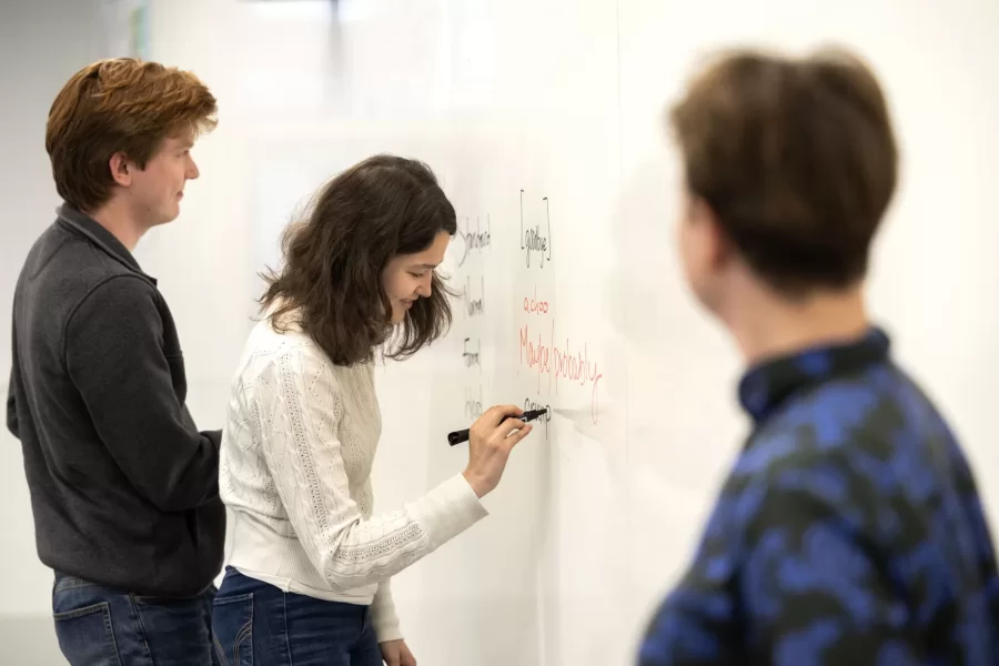 Aleisha Martinez Sandoval ’26 of of Edinburg, Texas, (left) and Caroline Cassell ’24 of Woodstock, Vt., listen in rapt attention to Otis speaker Nancy Campbell in a Dana Hall classroom as Campbell explains a writing exercise. Campbell met with Director of Student Writing and Lecturer in Humanities Bridget Fullerton and the peer-writing tutors at 4:15 in Dana 204.