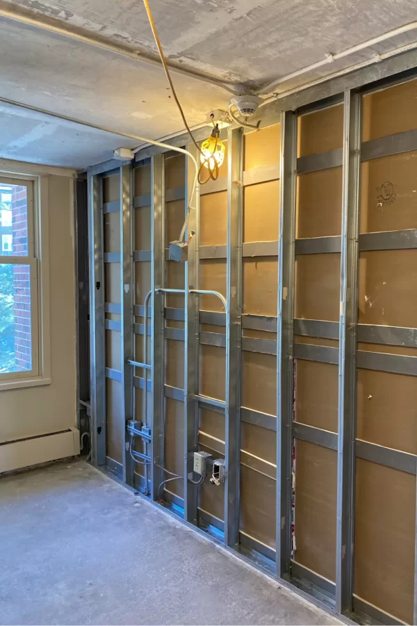 The dorm-room makeovers will include procedures to reduce noise leakage between rooms: Inside the connecting walls, acoustic insulation will be placed and the number of utility boxes reduced. Those boxes are surprisingly good at transmitting sound. (Doug Hubley/Bates College)