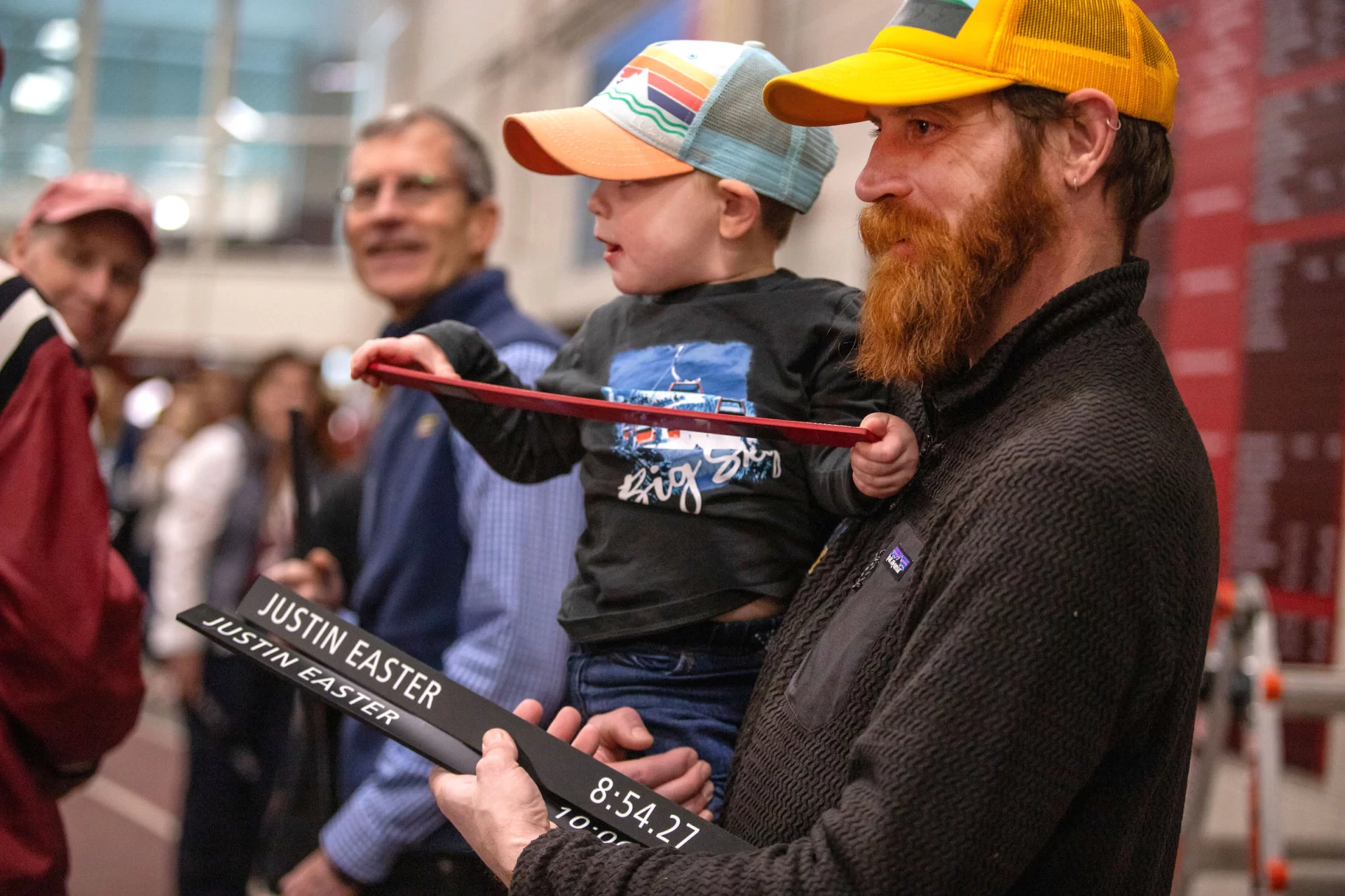 Alumni, current team members, and families gathered for a Track and Field Record Board dedication on Jan. 20.