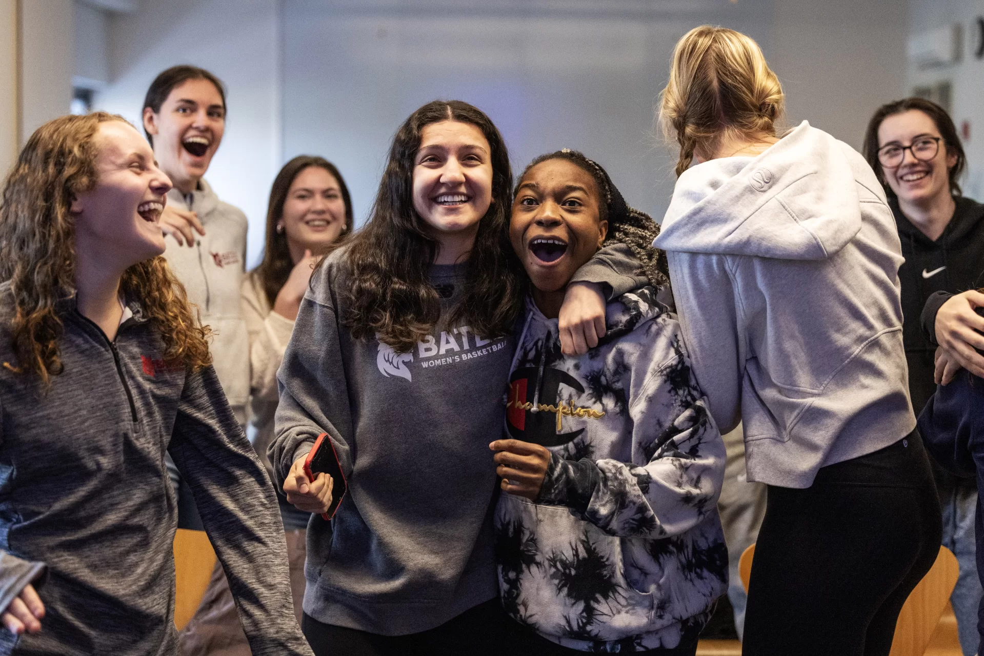 Bates College women’s basketball team reacts to being selected to participate in a NCAA tournament during a watch party in Commons 221 on February 26, 2024. (Theophil Syslo | Bates College)