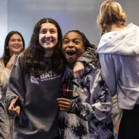 Bates College women’s basketball team reacts to being selected to participate in a NCAA tournament during a watch party in Commons 221 on February 26, 2024. (Theophil Syslo | Bates College)