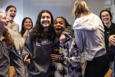 Bates College women’s basketball team reacts to being selected to participate in a NCAA tournament during a watch party in Commons 221 on February 26, 2024. (Theophil Syslo | Bates College)