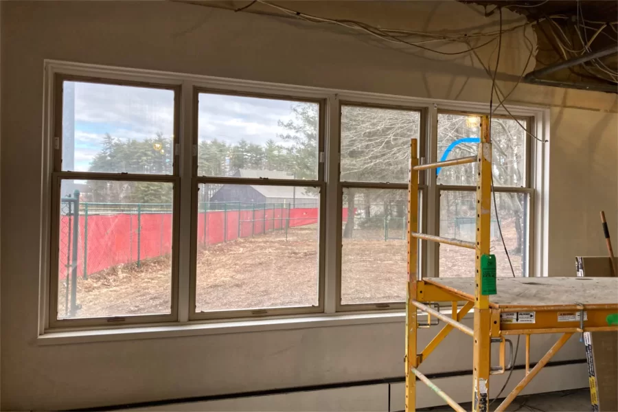 When the 96 Campus Avenue makeover is complete, these north-facing windows will show Merrill Gym and its adjacent woods. This room will become a lounge in the new student residence. (Doug Hubley/Bates College)