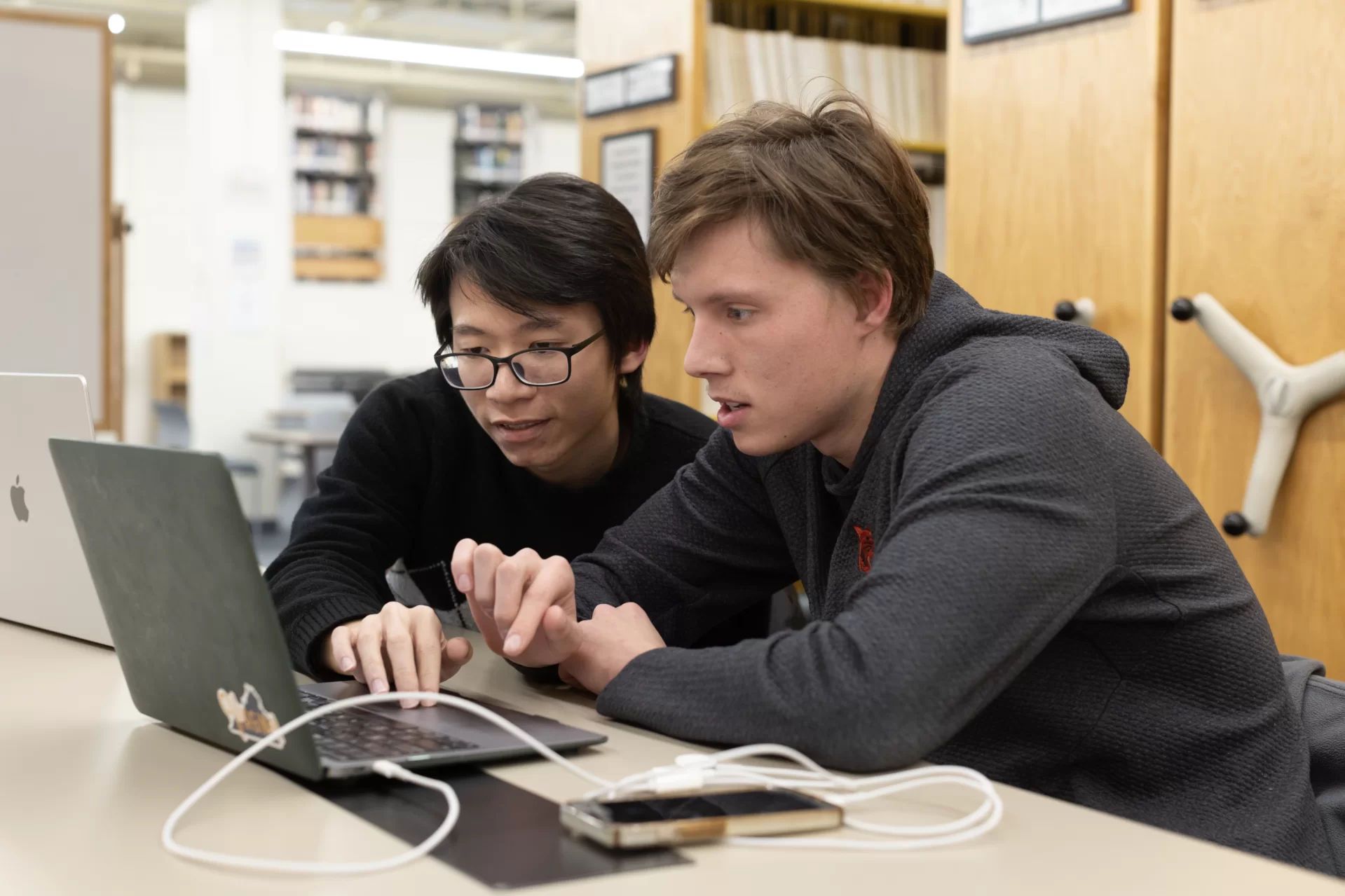 Students study in Ladd Library, Chase Hall, Roger Williams, and Hedge Hall during the early evening of Monday, March 19. Mathematics majors and classmates Duc Anh ’24 of Hanoi and Ethan Bean ’24 of Oaken, Va., are working together in Ladd Library’s Peer Learning Commons on a proposal for the Upcoming Bobcat Ventures event.