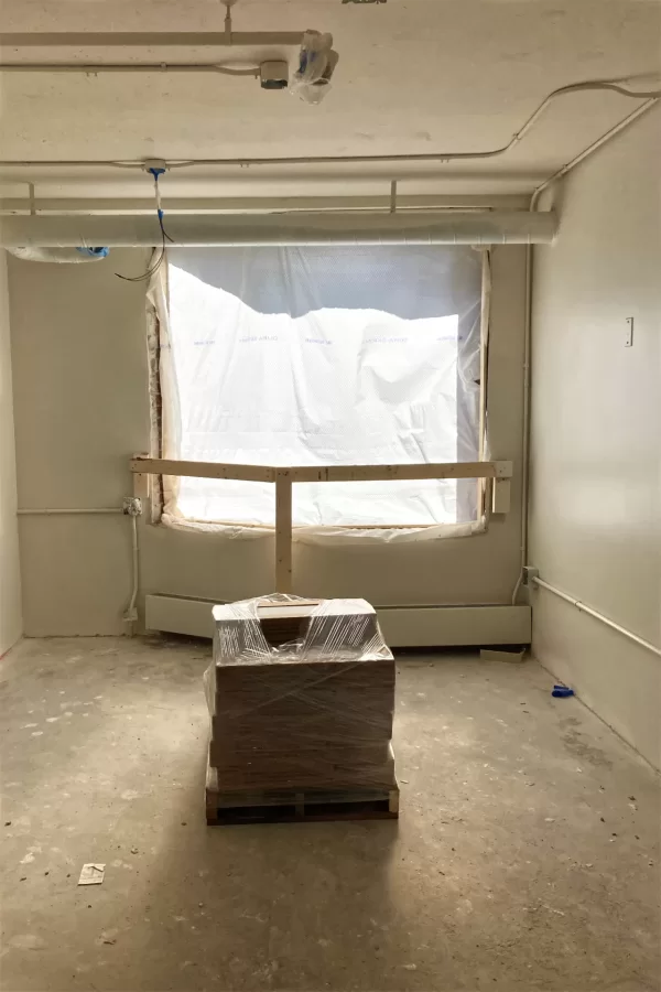 This student bedroom on the third floor of 96 Campus Ave. catches early-morning sun. On the pallet are tiles for the new restrooms. (Doug Hubley/Bates College)