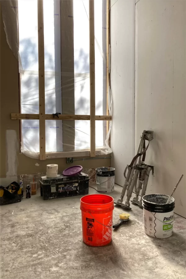 Tools, including a pair of drywall stilts, and supplies await the return of the person who’s applying joint compound in the student bedrooms being built in the former chapel at 96 Campus Ave. (Doug Hubley/Bates College)