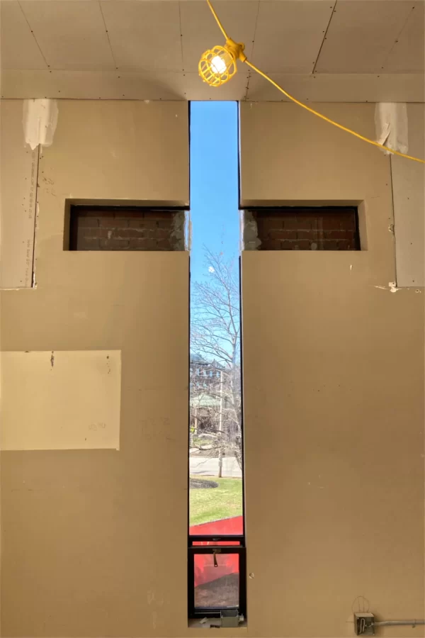 The original outline of a cross-shaped stained-glass window remains in what had been the chapel when 96 Campus Ave., originally a convent, was built. The horizontal bar has been bricked in. (Doug Hubley/Bates College)