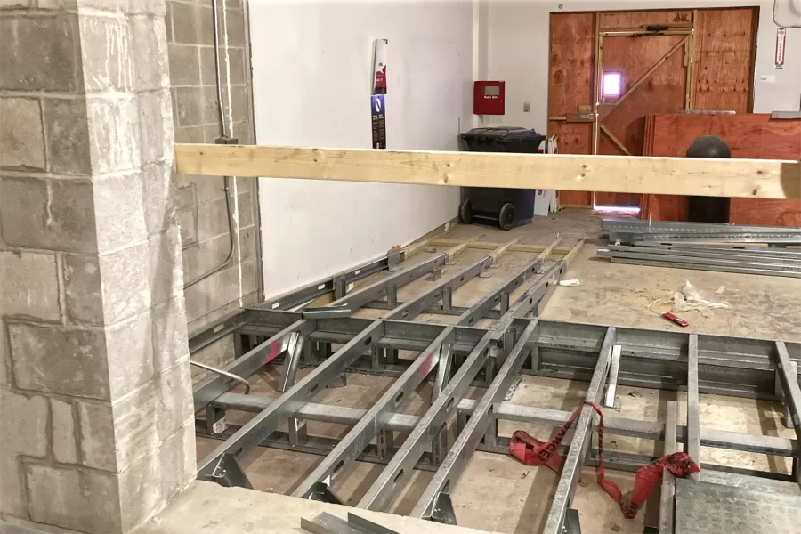 As part of the 96 Campus Ave. renovation, the former loading bay is being transformed into the building’s main entrance. The new metal structure at bottom will support a raised flooring section incorporating an ADA-compliant ramp. (Doug Hubley/Bates College)