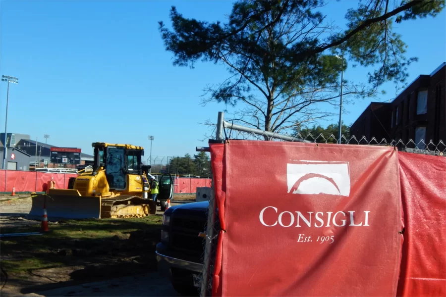Consigli Construction has managed several major building projects at Bates, including the conversion of 96 Campus Ave., at right behind the site fence, into student housing. (Doug Hubley/Bates College)