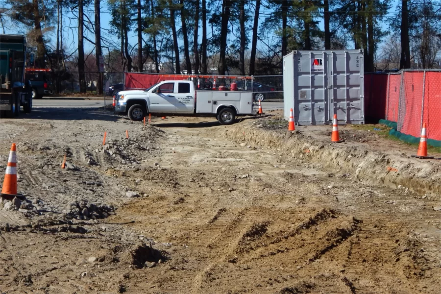 Pavement has been removed from the 96 Campus Ave. parking lot in preparation for utilities work and then a reconfiguring of the lot and surroundings. The trench shown here will be deepened to about four feet for the placement of utility lines.(Doug Hubley/Bates College)