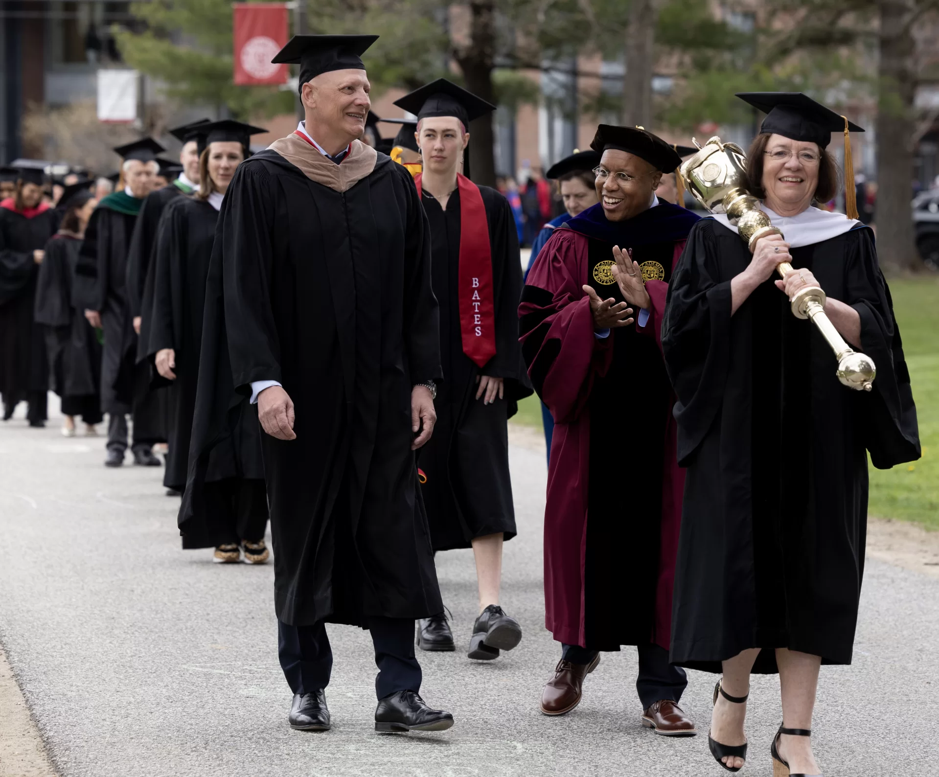 Scenes from inauguration of Garry W. Jenkins, including robing in Commons, installation in Merrill Gymnasium, and Presidential Luncheon on Bardwell Street tents.

As Garry W. Jenkins, Bates College’s ninth president, received the figurative, and literal, keys to Bates’ future as its new leader today, he did so with gratitude, compassion, and determination. 

Before the roughly 1,000 guests in Merrill Gymnasium, Jenkins promised he would lead Bates “with humility and transparency, with tenacity and enthusiasm, and, of course, with ardor and devotion.”

Offering four cornerstones that “will guide our work and propel us forward” and asking the Bates community to “embrace the challenges that await us,” Jenkins emphasized how now more than ever Bates needs to promote teamwork, to remove barriers to students, to become more inclusive, and to cultivate and prepare leaders for tomorrow’s challenges.

By doing so, he said, Bates will become stronger while serving society and democracy. “They rise together.”