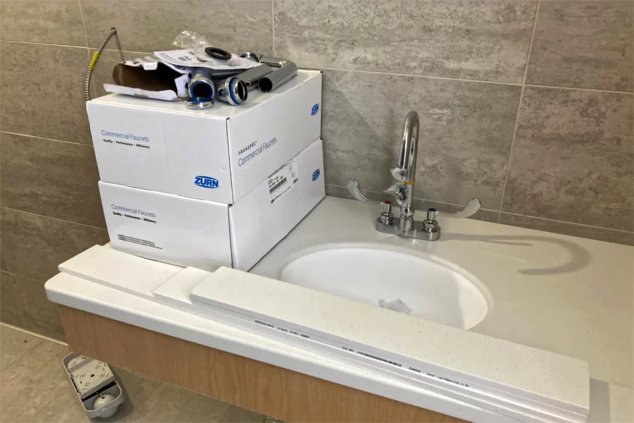 Installation of fixtures in third-floor restrooms is underway. (Doug Hubley/Bates College)
