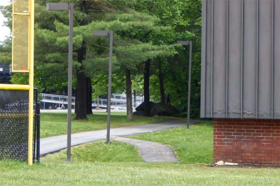 The path at center will be connected to new walkway leading to 96 Campus Avenue, which is behind the camera. The Bobcat sculpture appears in the background. (Doug Hubley/Bates College)