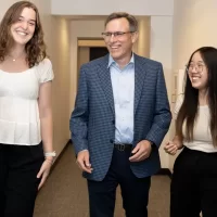 Linh Vu ’26 , a double major in mathematics and economics from Hanoi, and environmental studies major Drew Williams ’25 of Guilford, Conn., pose for photographs at Promethos Capital, a Boston-based investment boutique focused on global equity investments with Joe Sylvester ’90, founder, director of research and managing partner, and Ifka Klaus, founder, chief investment officer, and managing partner. The two students have Purposeful Work-funded internships at the firm, located at 101 Federal Street.