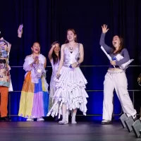 Bates people on stage in costumes made from recycled materials