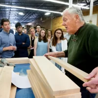 "My introduction to business was through Aristotle." -- Thomas Moser, a master craftsman whose handmade furniture beautifies public spaces around the world, explaining the importance of a liberal arts education. Students in the "Short Term Practicum: Brand Culture Building" (including Lois Masson '16 of Petit-Lancy, Switzerland, and Clarke Shipley '17 of Andover, Mass., pictured here) listened to the internationally acclaimed furniture designer as he offered them a tour of his Thos. Moser Cabinetmakers workshop in Auburn, Maine. Moser, a former speech professor and debate coach at Bates, received an honorary doctor of humane letters from the college in 2015. This course, taught by brand strategist Peter Bysshe '93, takes students behind the scenes of brand culture consultants in an effort to not only humanize intimidating large corporate cultures, but also to arm students with tools to observe, measure, and build, manage or contribute to smaller cultures in which they may find themselves after graduating.