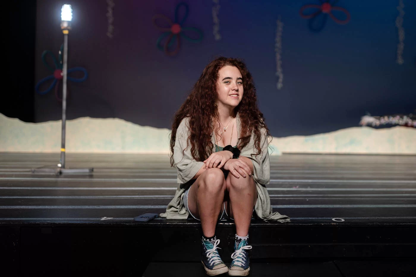 person posing on a theater stage