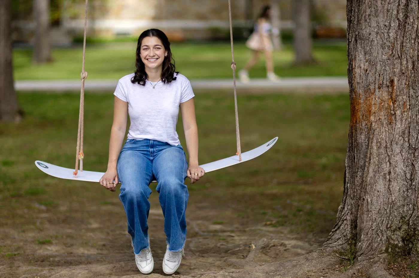 person posing sitting on rope swing