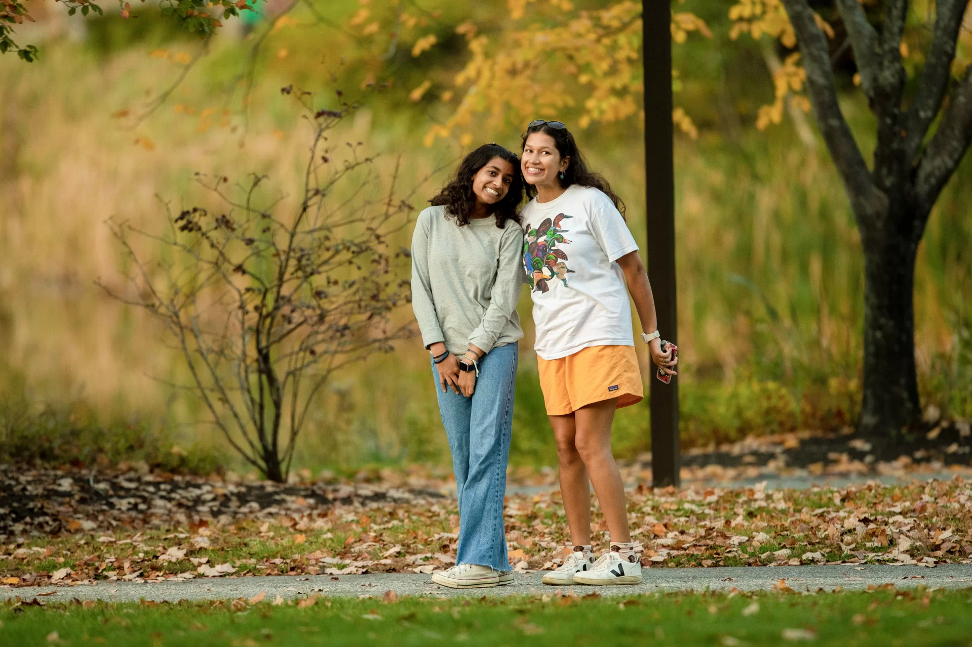 Aanika Patel ’25 (left) showing a friend (on right) from home around a fall campus.