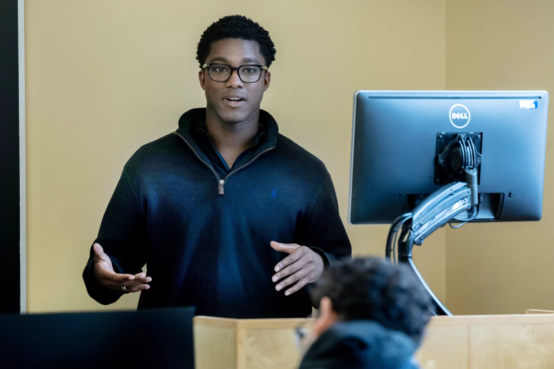 student presenting at a lectern