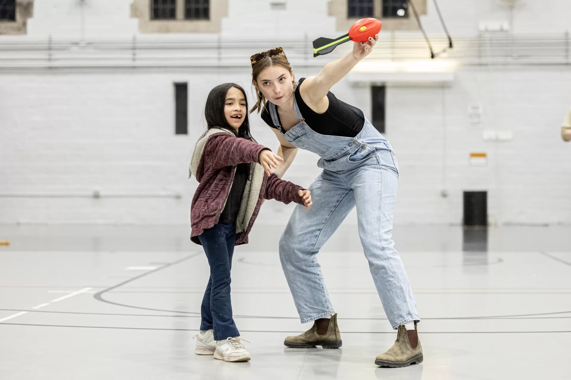 It Sounds Fun
Mikaila Whitaker Bennett ’28 of Rowley, Mass., demonstrates the Doppler effect using a Nerf rocket with Jorah Robbins, age 7 of Auburn, during the annual Astronomy Extravaganza on April 14 in the Gray Athletic Building.
As part of the station “Doppler’s Dynamic Dance of Sound,” Bates students explained how sound waves compress as an object moves toward you — raising the pitch of the sound — and expand as it moves away, lowering the pitch. (Think of the changing pitch of a siren as it approaches and departs.)
The community event, created in 2017 by Associate Professor of Physics Aleks Diamond-Stanic and deployed by students in his introductory astronomy course, featured dozens of interactive activities tailored to students from Lewiston and Auburn elementary schools, grades three through six.
Hands-on demonstrations, telescope viewing, and mini-planetarium shows helped children explore moon phases, star constellations, and the movement of celestial bodies.
The Bates Astronomy set up several telescopes outside of Gray so that children — and club members — could view Jupiter in the skies above.
The event is made possible through a collaboration with the Harward Center for Community Partnerships and staff of the Department of Physics and Astronomy.
(Phyllis Graber Jensen/Bates College)
#batescollege #astronomy #community #lewiston #auburn #celestial