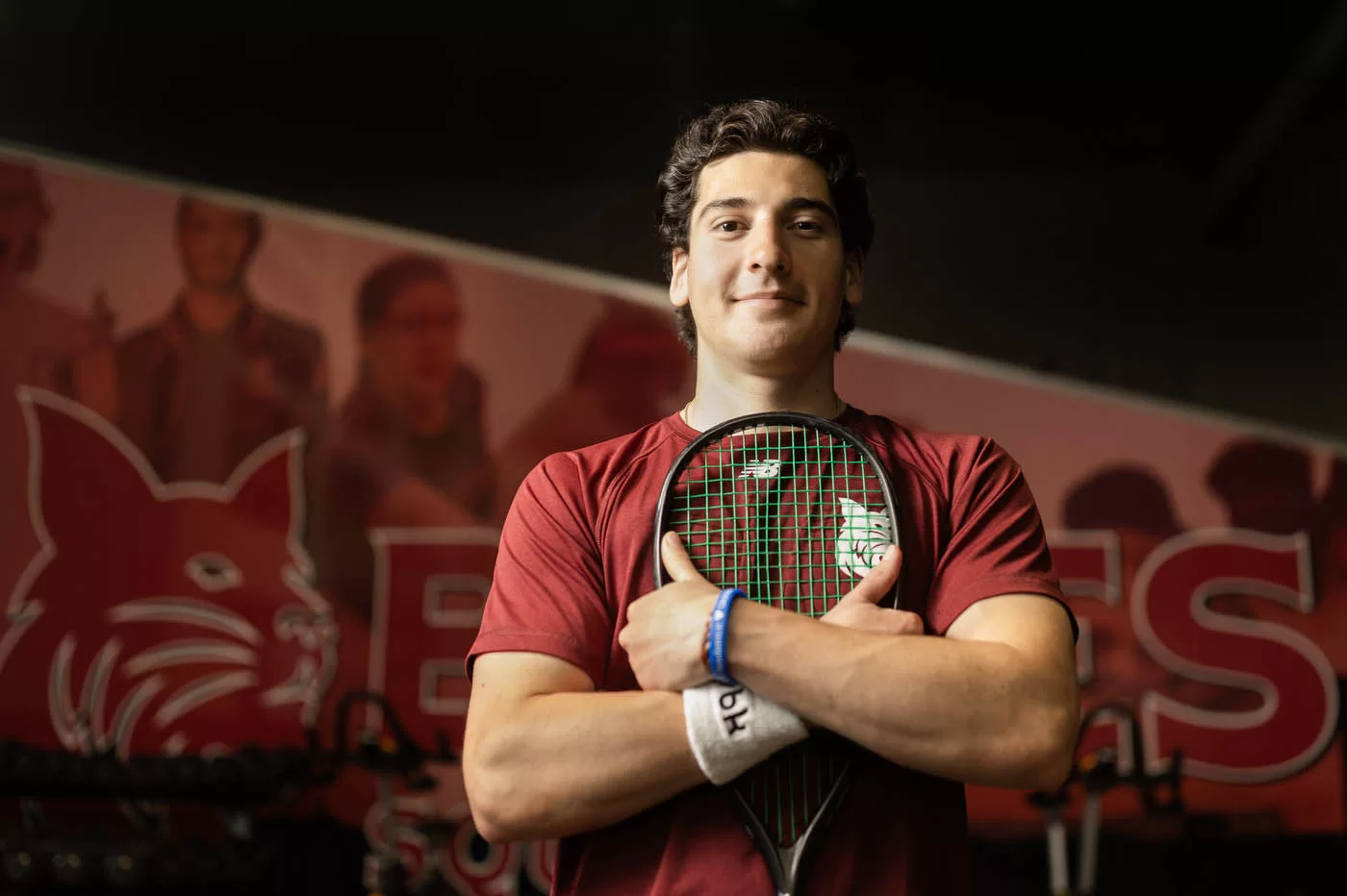 person posing with a squash racquet