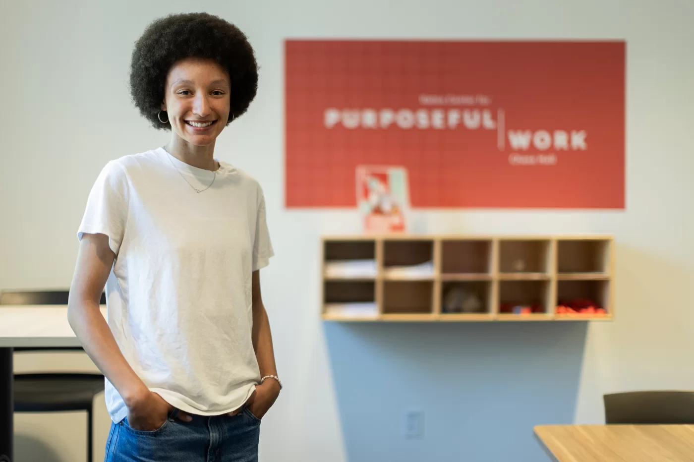 person standing in front of a Purposeful Work sign