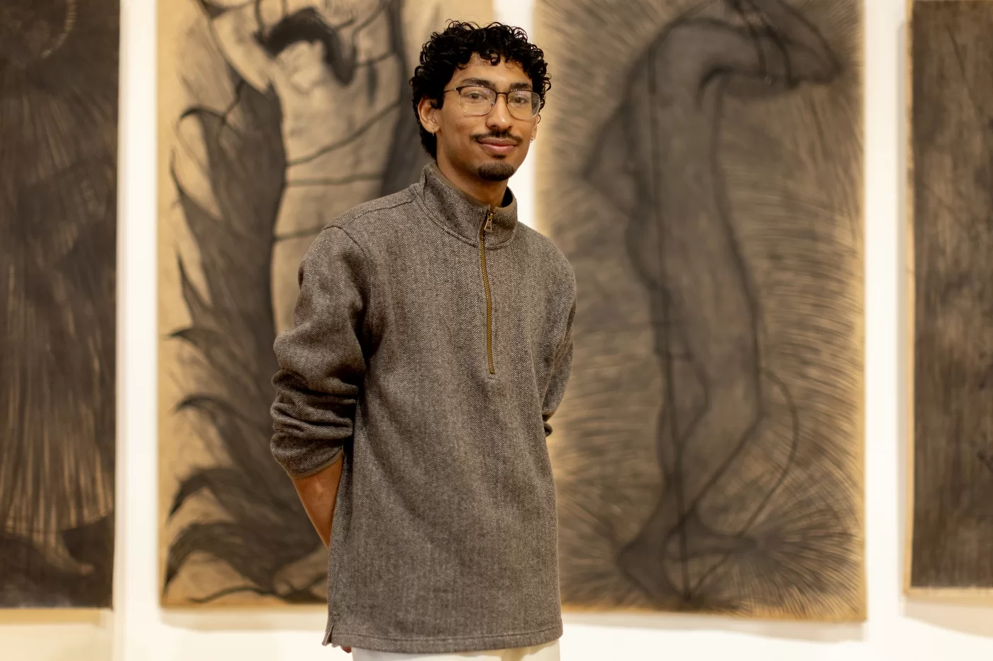 person posing in front of artwork