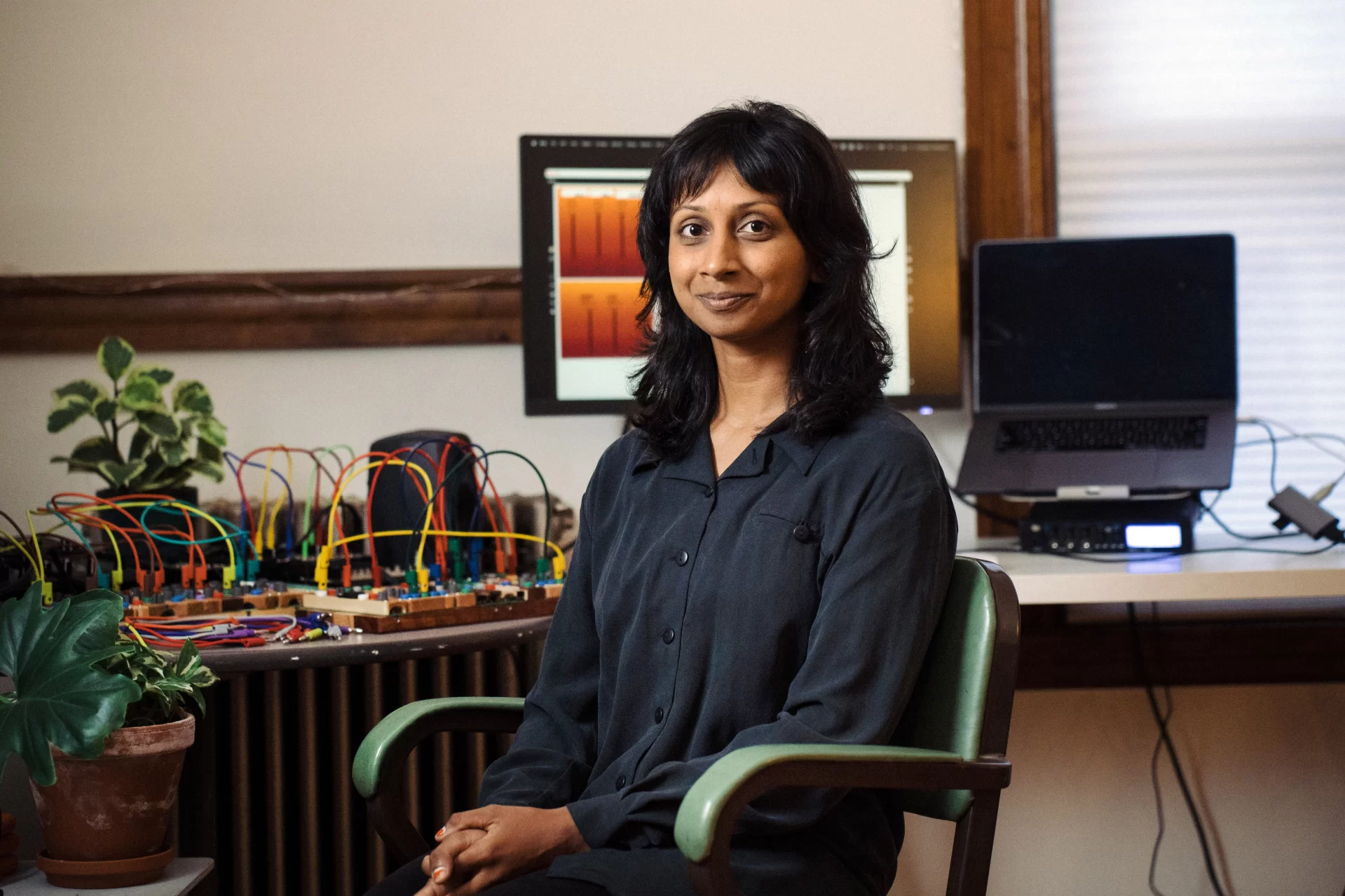 person sitting in chair in front of computer