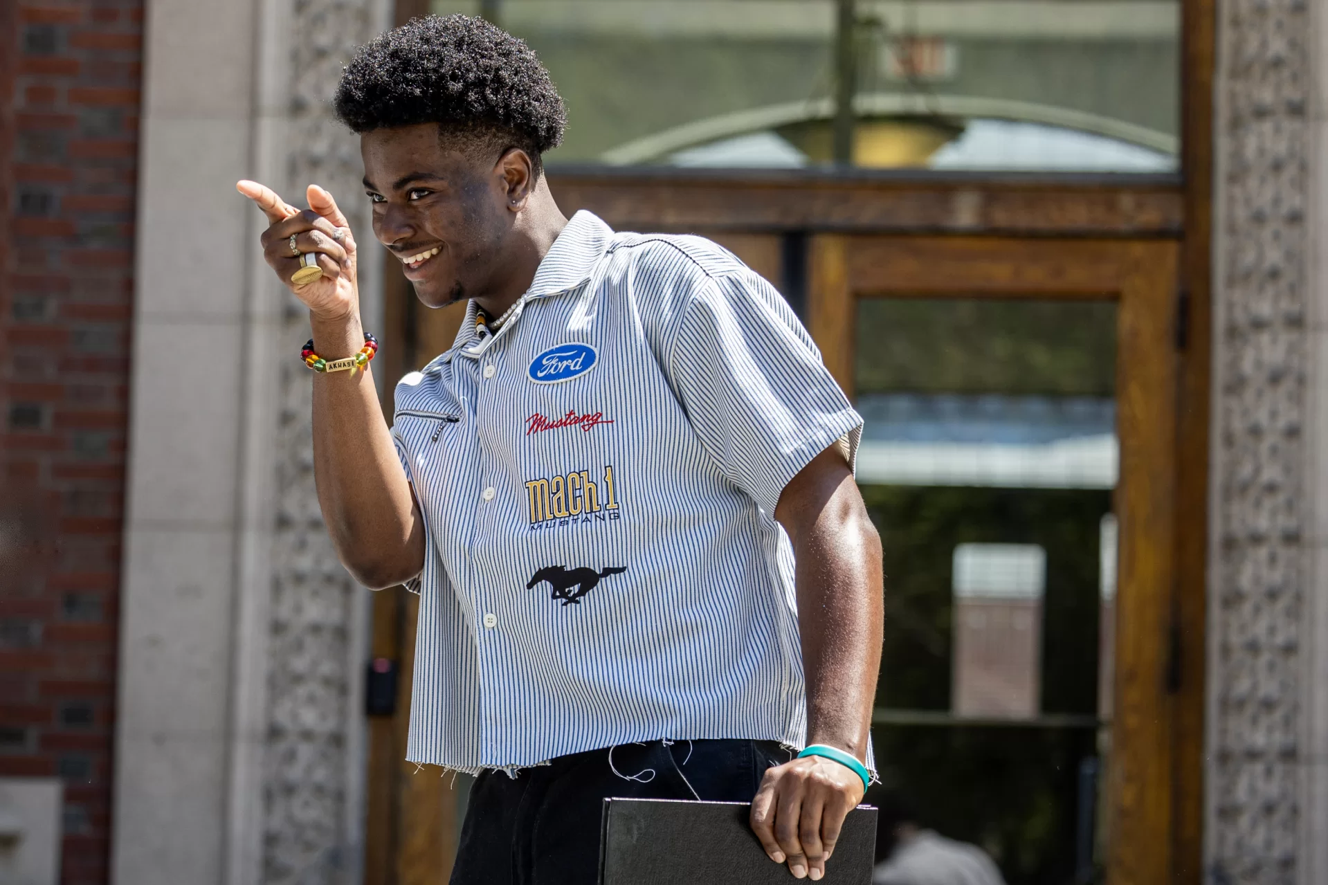 Uche Anyanwu ’25 of Brooklyn, N.Y. binds his senior thesis , advised by Visiting Instructor in Economics Xinhao Wang, on the steps of Coram Library on May 14, 2025, with friends, faculty, and staff. The thesis is titled “Entertainment and Media’s Effect on Economies in Sub-Saharan Africa.”